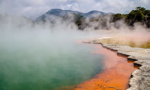 Volcanic water with orange minerals release vaoup over the natural landscape on a Rotorua superyacht charter